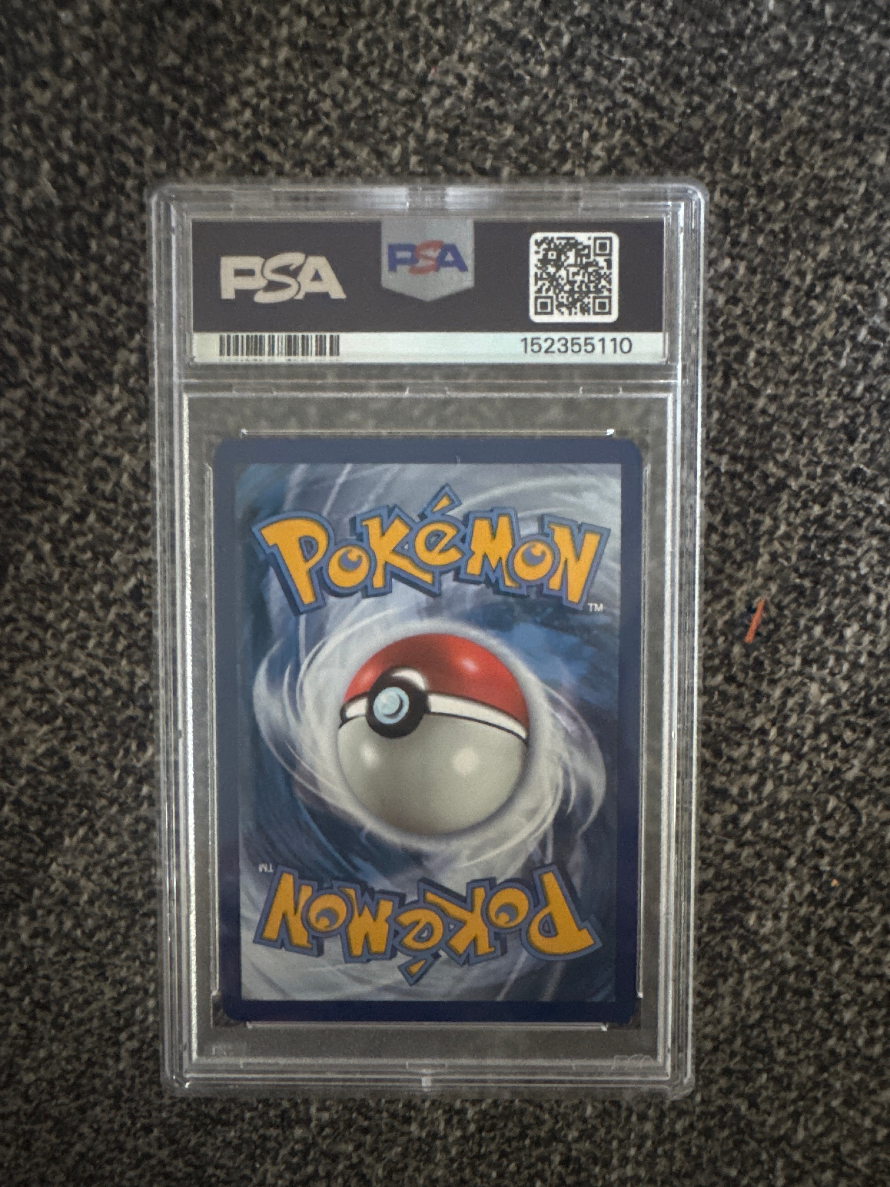Rear of the same PSA Charizard slab showing the Pokémon card back and reverse label